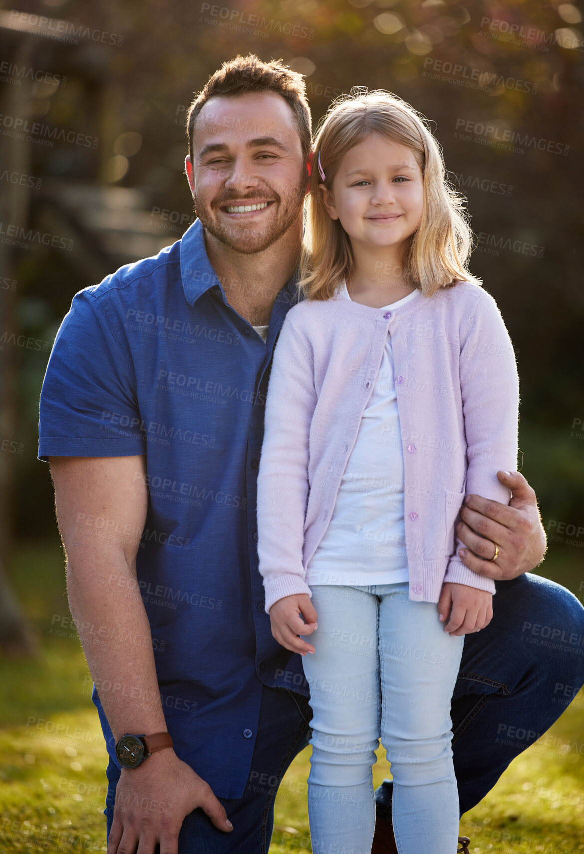 Buy stock photo Cropped portrait of a handsome young man and his daughter posing outside in the garden at home