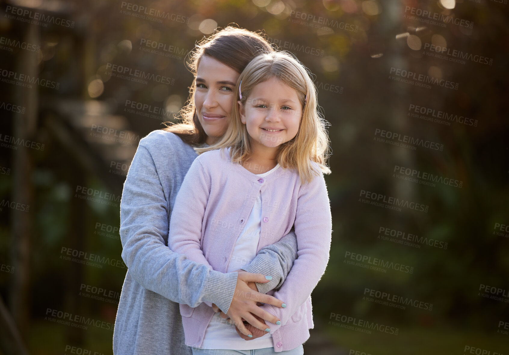 Buy stock photo Portrait, hug and family with smile, girl and mother with happiness, care and love. Face, single parent and mama with daughter, childhood or kid in backyard at home, embrace or time together with joy