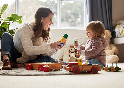 Buy stock photo Shot of a young mother and daughter playing at home