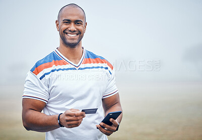 Buy stock photo Shot of a young male athlete using his smartphone to make online card payments