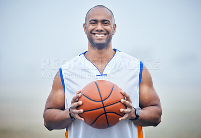 Buy stock photo Shot of a young male basketball player holding the ball