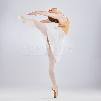 Buy stock photo Studio shot of a young woman performing a ballet recital against a grey background