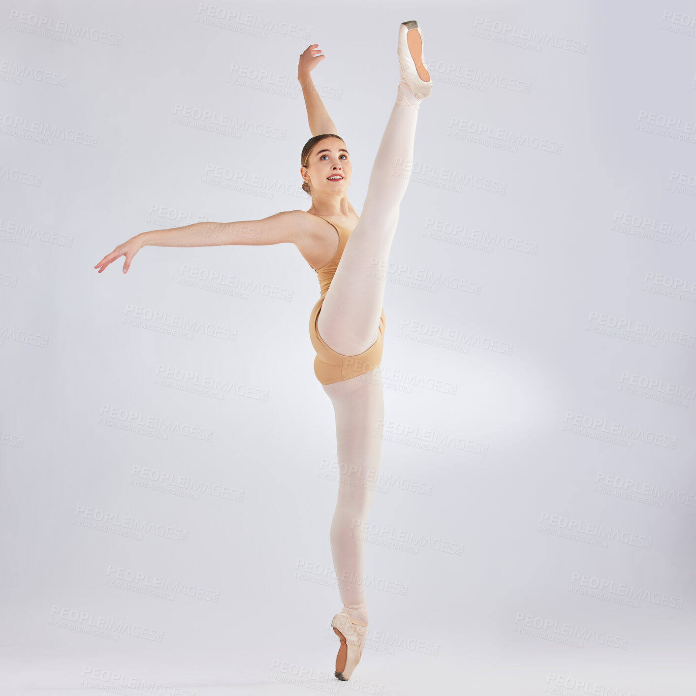 Buy stock photo Studio shot of a young woman performing a ballet recital against a grey background
