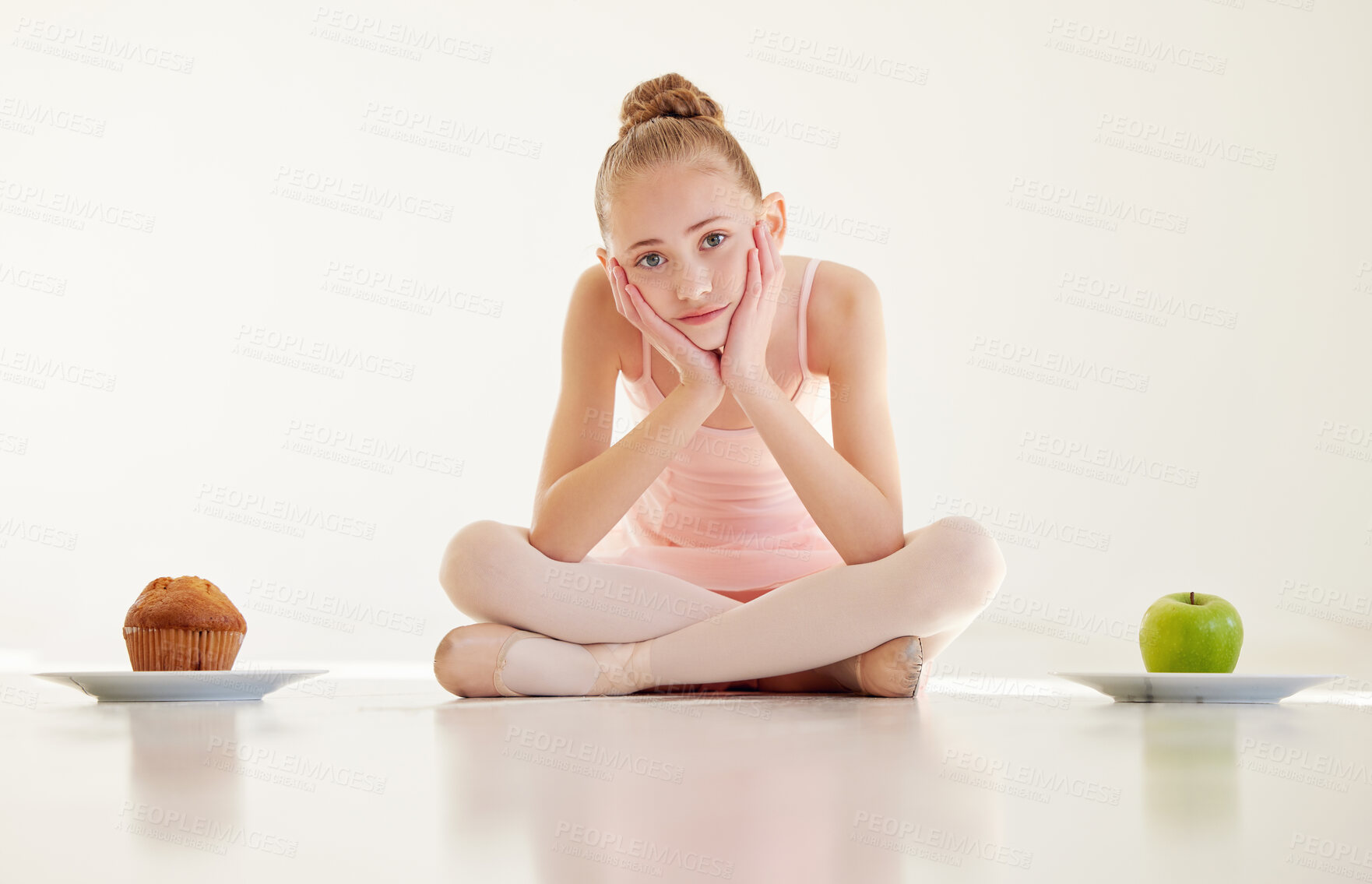 Buy stock photo Shot of a young ballerina  deciding what to eat in a studio