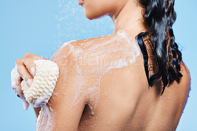 Buy stock photo Cropped shot of an unrecognizable woman enjoying a soapy shower against a blue background