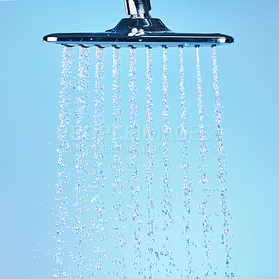Buy stock photo Shot of an empty running shower against a blue background