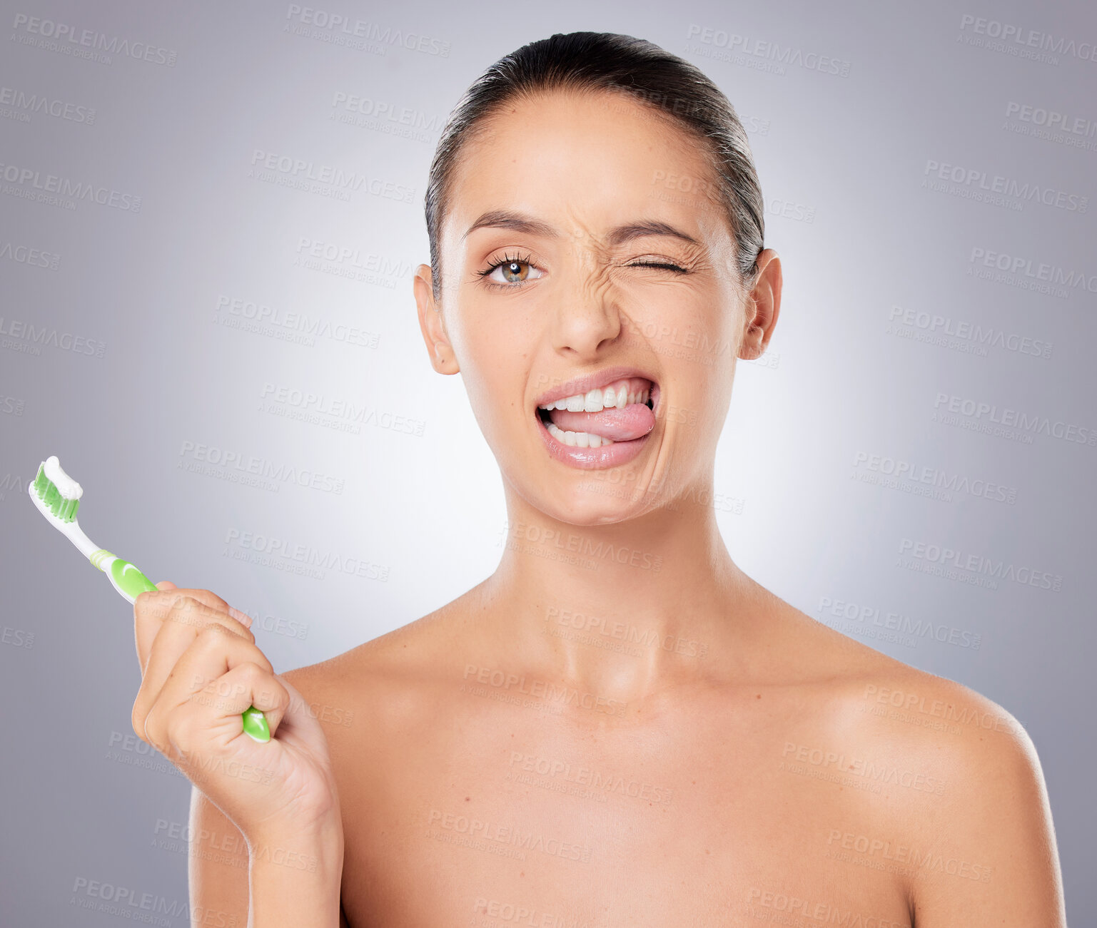 Buy stock photo Shot of a beautiful young woman brushing her teeth against a grey background