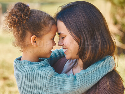 Buy stock photo Shot of a young mother affectionately hugging during a picnic