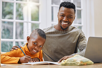 Buy stock photo Shot of a young father helping his son with homework at home