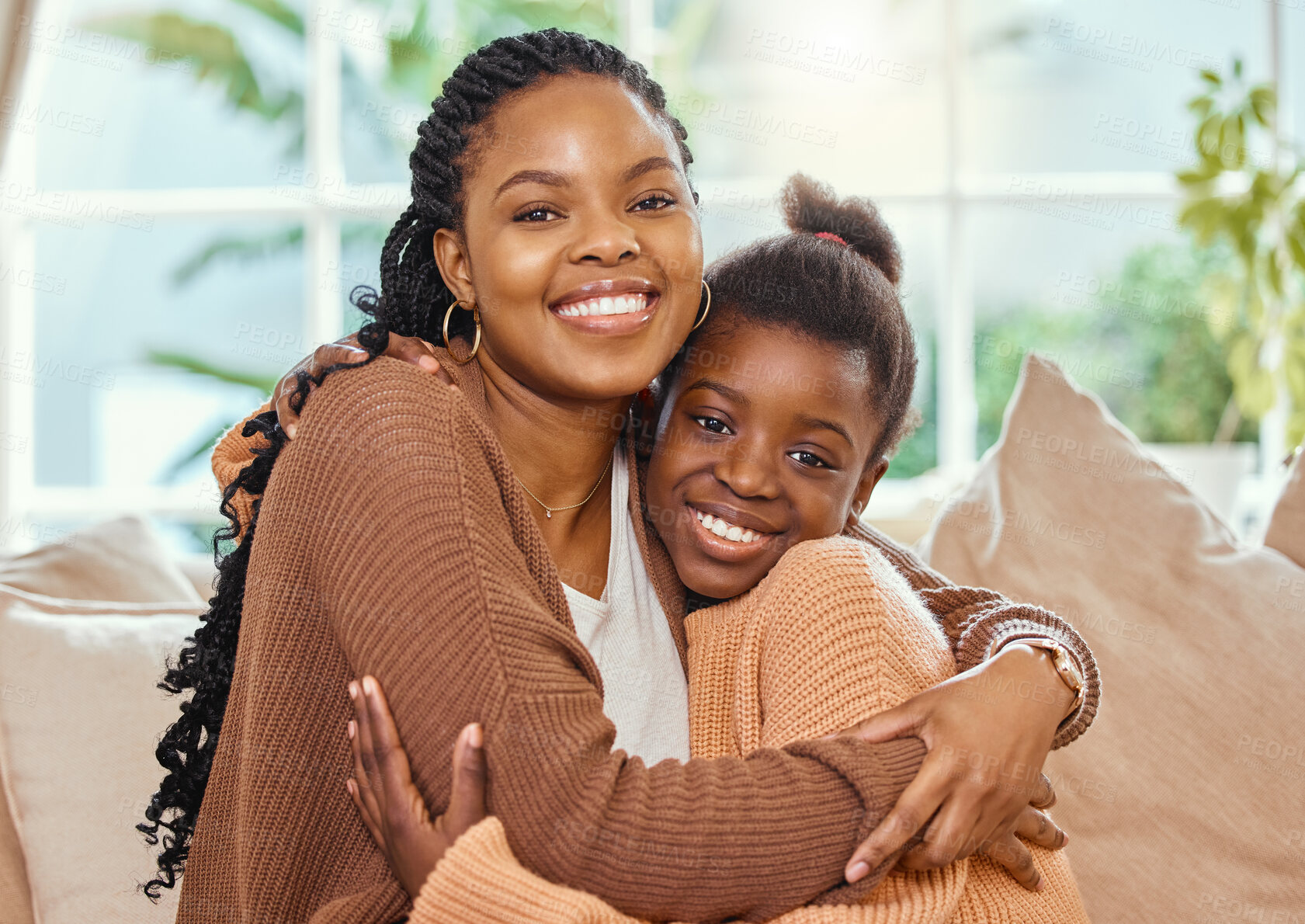 Buy stock photo Shot of a young mother hugging her daughter