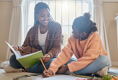 Buy stock photo Shot of a young boy completing his homework while his mom helps him and his sister