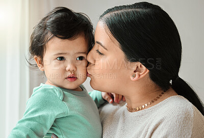 Buy stock photo Shot of a beautiful young woman bonding with her baby at home