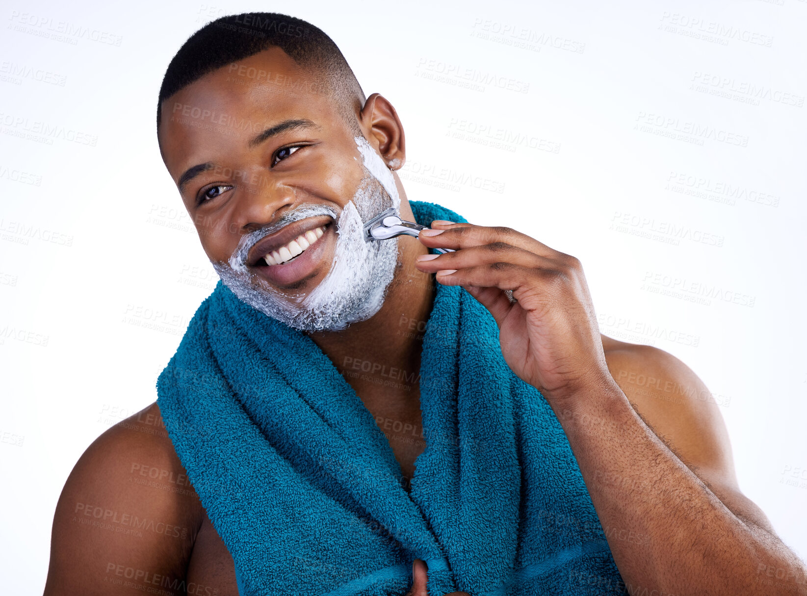 Buy stock photo Studio shot of a handsome young man shaving against a white background