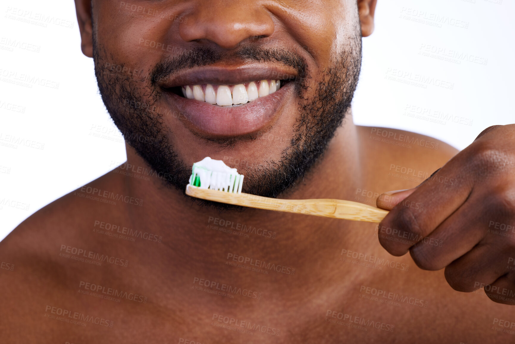Buy stock photo Studio shot of an unrecognizable young man brushing his teeth against a white background