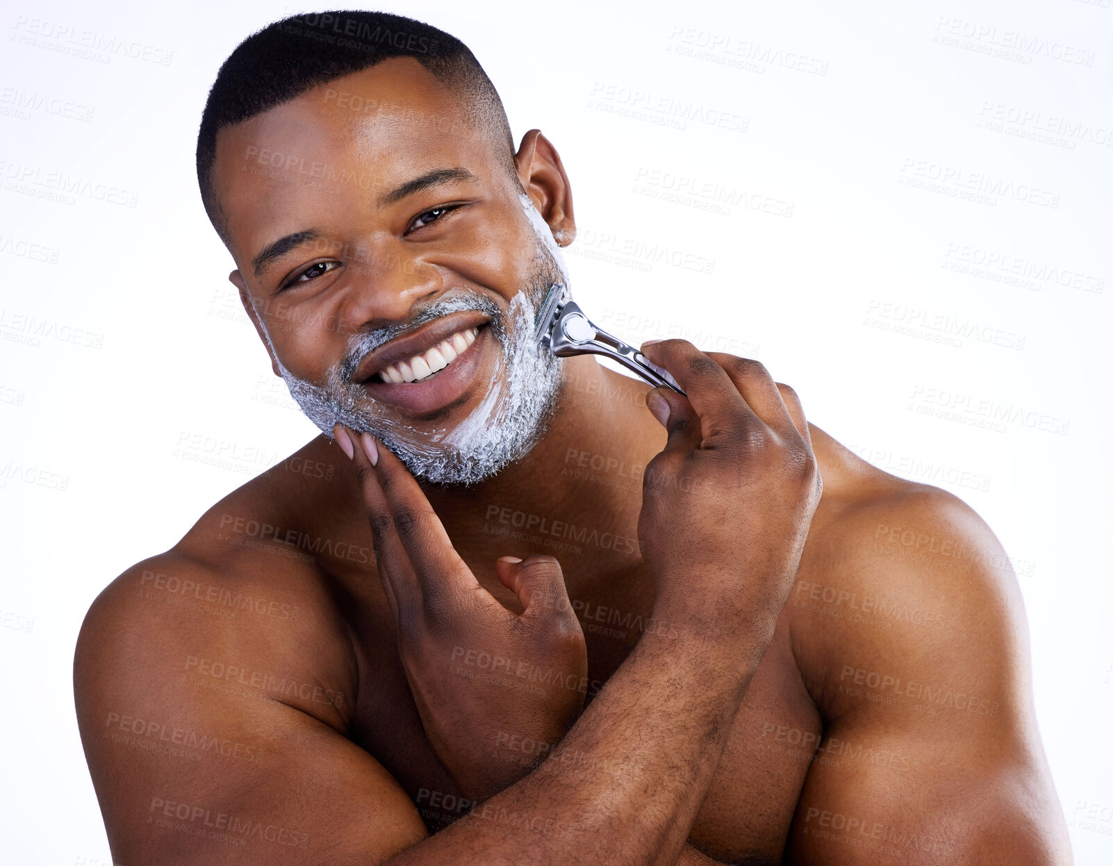 Buy stock photo Studio portrait of a handsome young man shaving against a white background