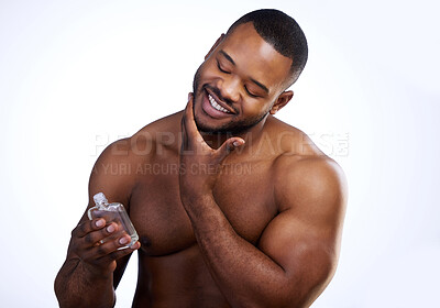 Buy stock photo Studio shot of a handsome young man applying cologne against a white background