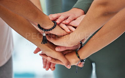Buy stock photo Cropped shot of an unrecognisable group of women huddled together with their hands stacked in the middle after yoga
