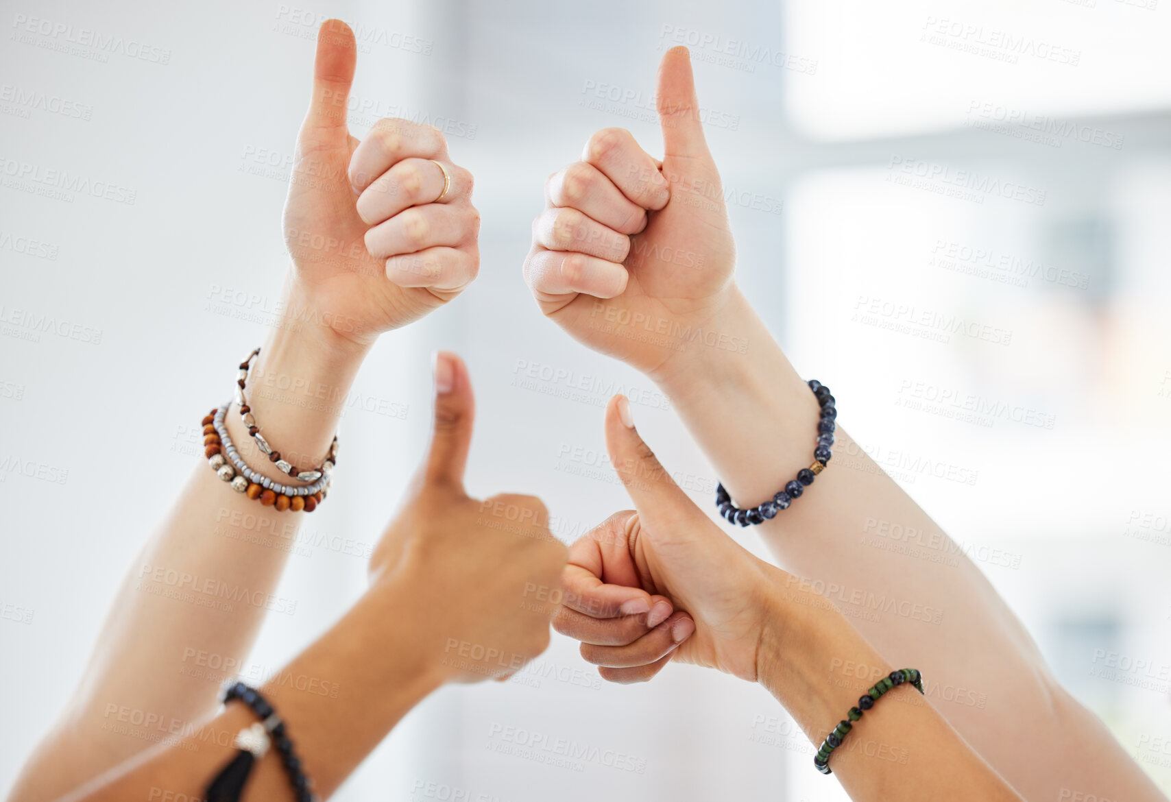 Buy stock photo Cropped shot of an unrecognisable group of women huddled together and showing a thumbs up after yoga practise