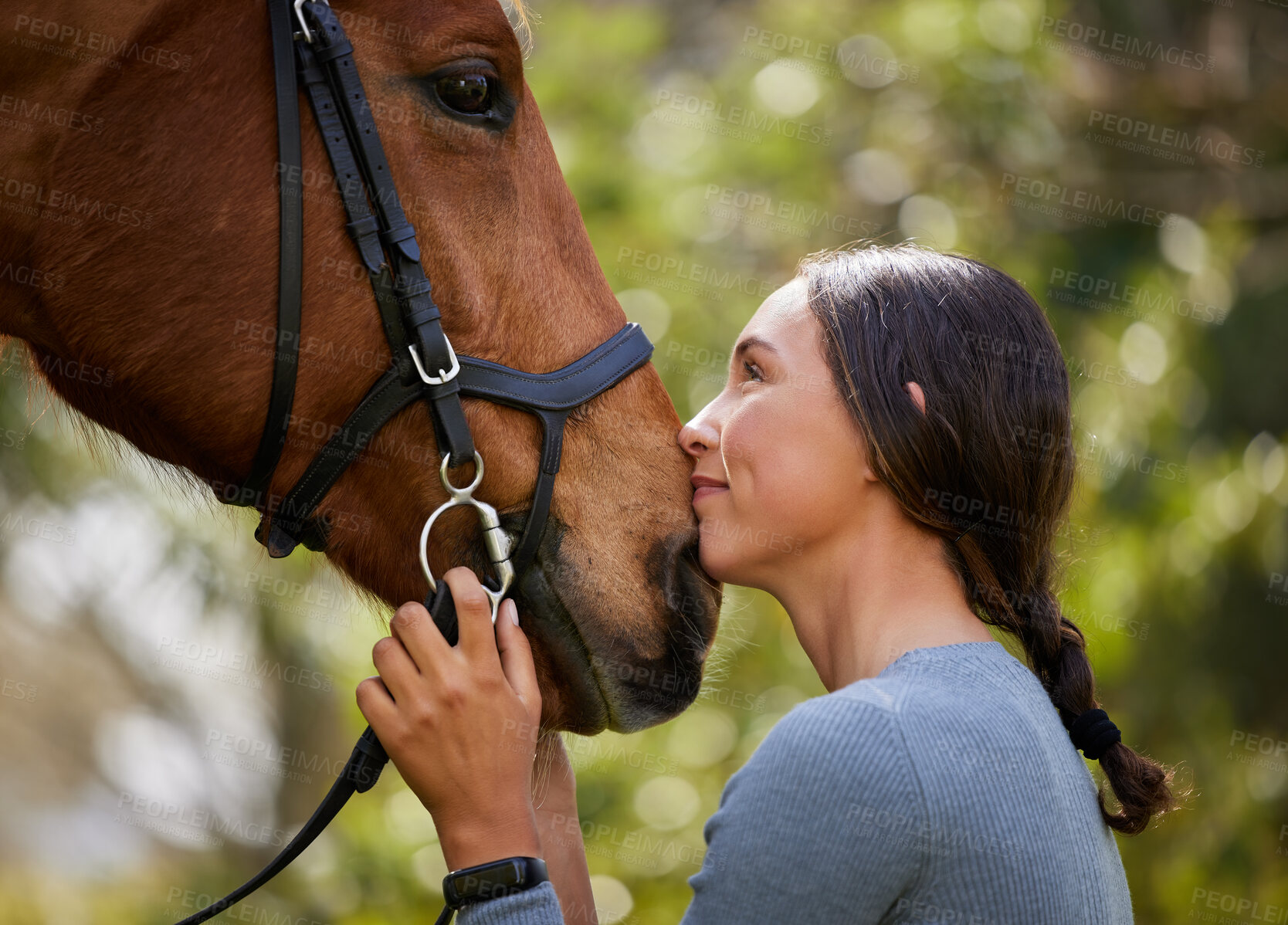 Buy stock photo Shot of an attractive young woman standing with her horse in a forest