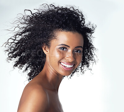 Buy stock photo Studio portrait of a gorgeous young woman smiling while standing topless against a grey background