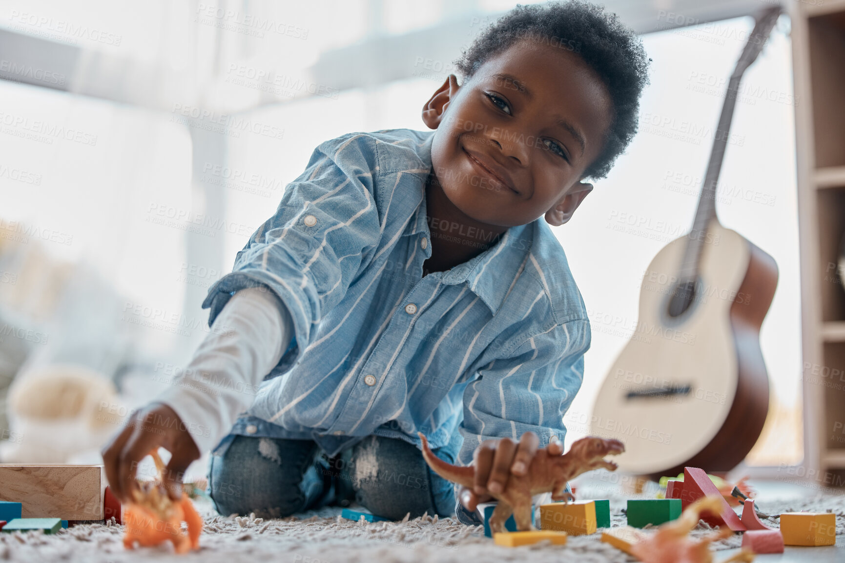 Buy stock photo Boy, home and happy with toys in portrait on floor for fun, relax and break for child development. Bedroom, kid and smile with plastic dinosaur for playing games and chill for childhood memories