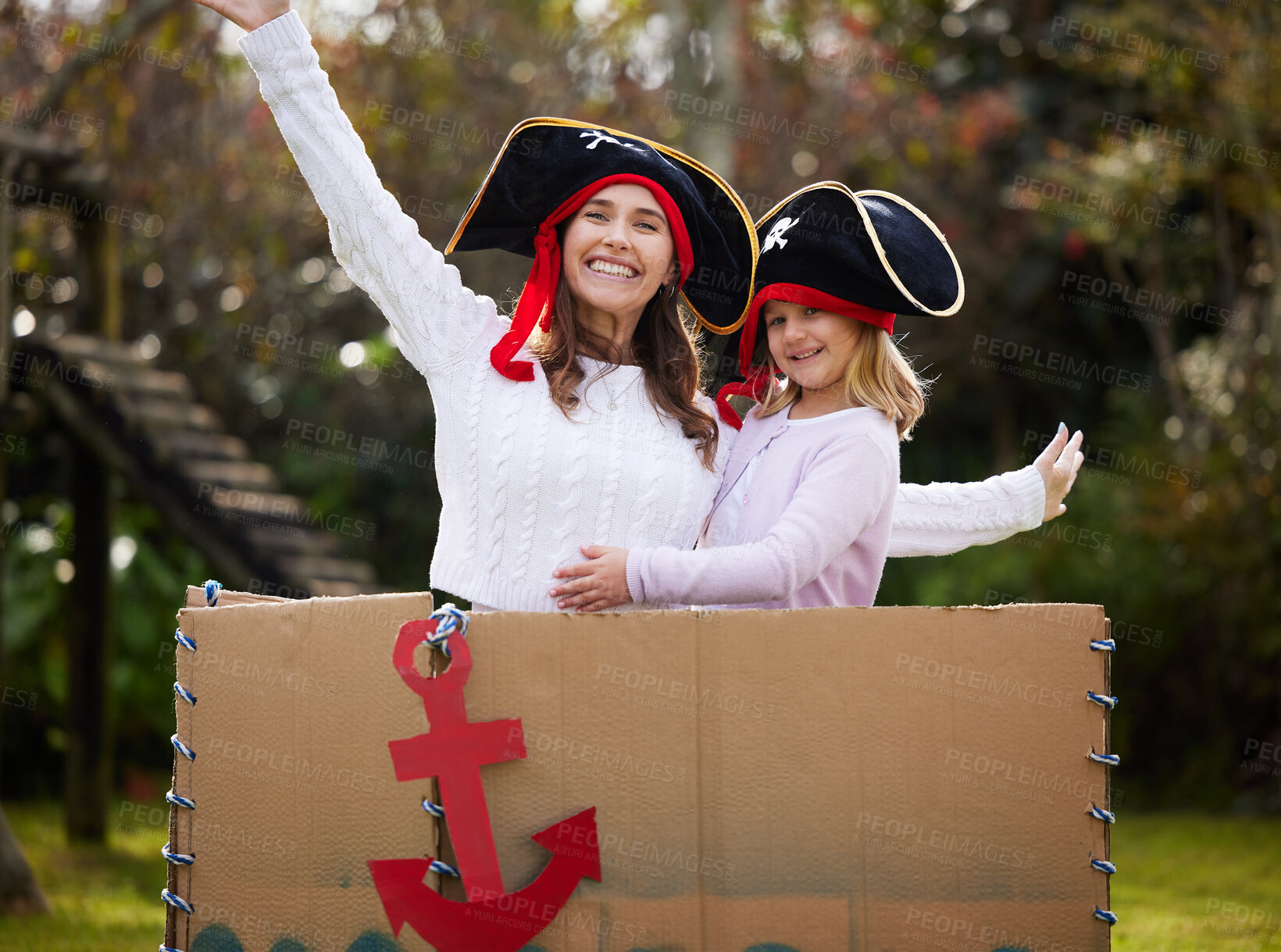 Buy stock photo Portrait, pirates and mother with girl, costume and playful in garden, happiness and time together. Face, family and mama with daughter, kid and fun with childhood, love and Halloween with cardboard