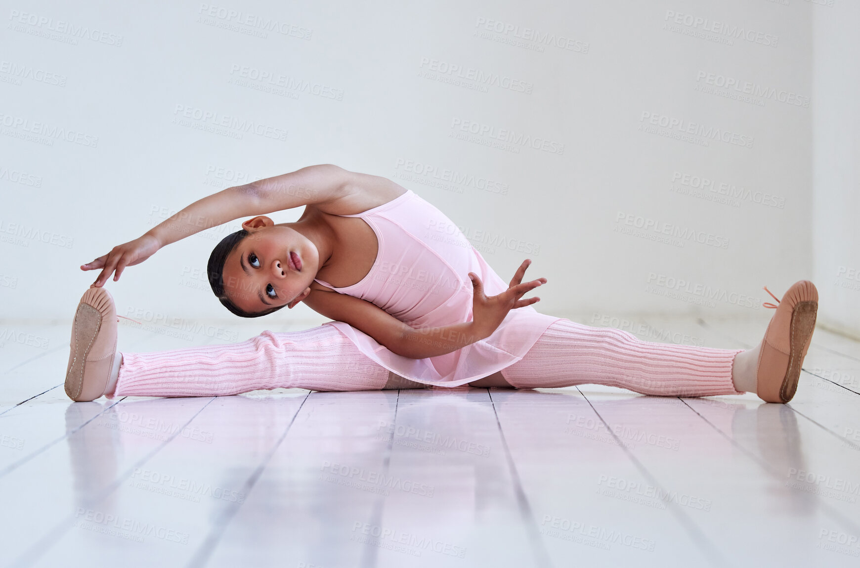 Buy stock photo Shot of a little girl doing the splits in a ballet studio