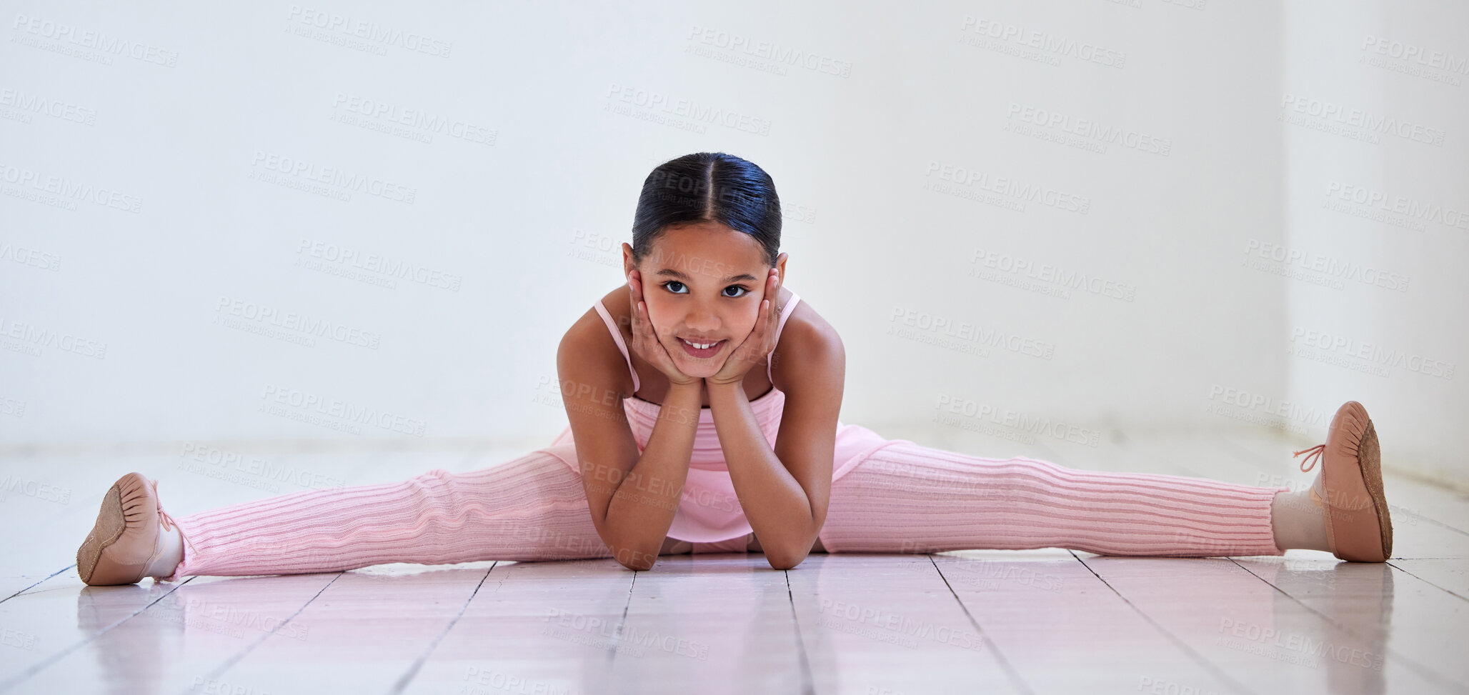 Buy stock photo Portrait of a little girl doing the splits in a ballet studio