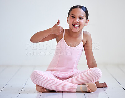 Buy stock photo Shot of a little girl showing thumbs up in a ballet studio