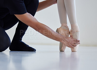 Buy stock photo Closeup shot of a ballet teacher assisting a student with her position in a dance studio
