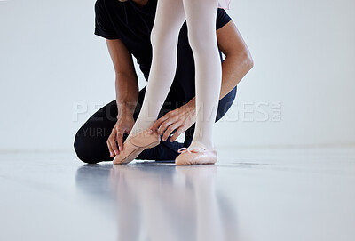 Buy stock photo Closeup shot of a ballet teacher assisting a student with her position in a dance studio