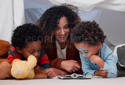 Buy stock photo Shot of a young mother using a digital tablet with her children at home