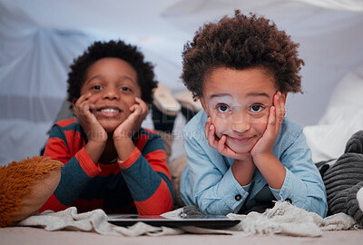 Buy stock photo Shot of two little brothers using a digital tablet together at home