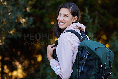Buy stock photo Shot of an attractive young woman standing alone outside and carrying a backpack