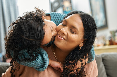 Buy stock photo Shot of an adorable little girl giving her mother kiss while bonding with her in the living room at home