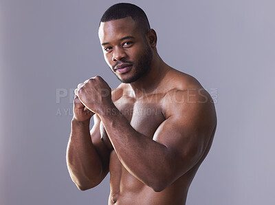 Buy stock photo Studio shot of a handsome young man boxing against a grey background
