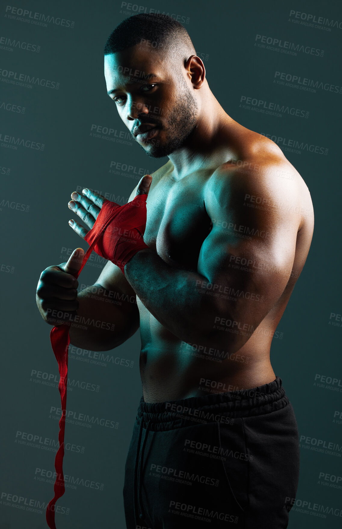 Buy stock photo Shot of a handsome young man boxing against a studio background