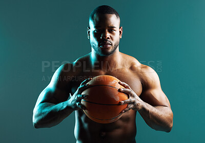 Buy stock photo Studio shot of a	muscular young man playing basketball against a green background