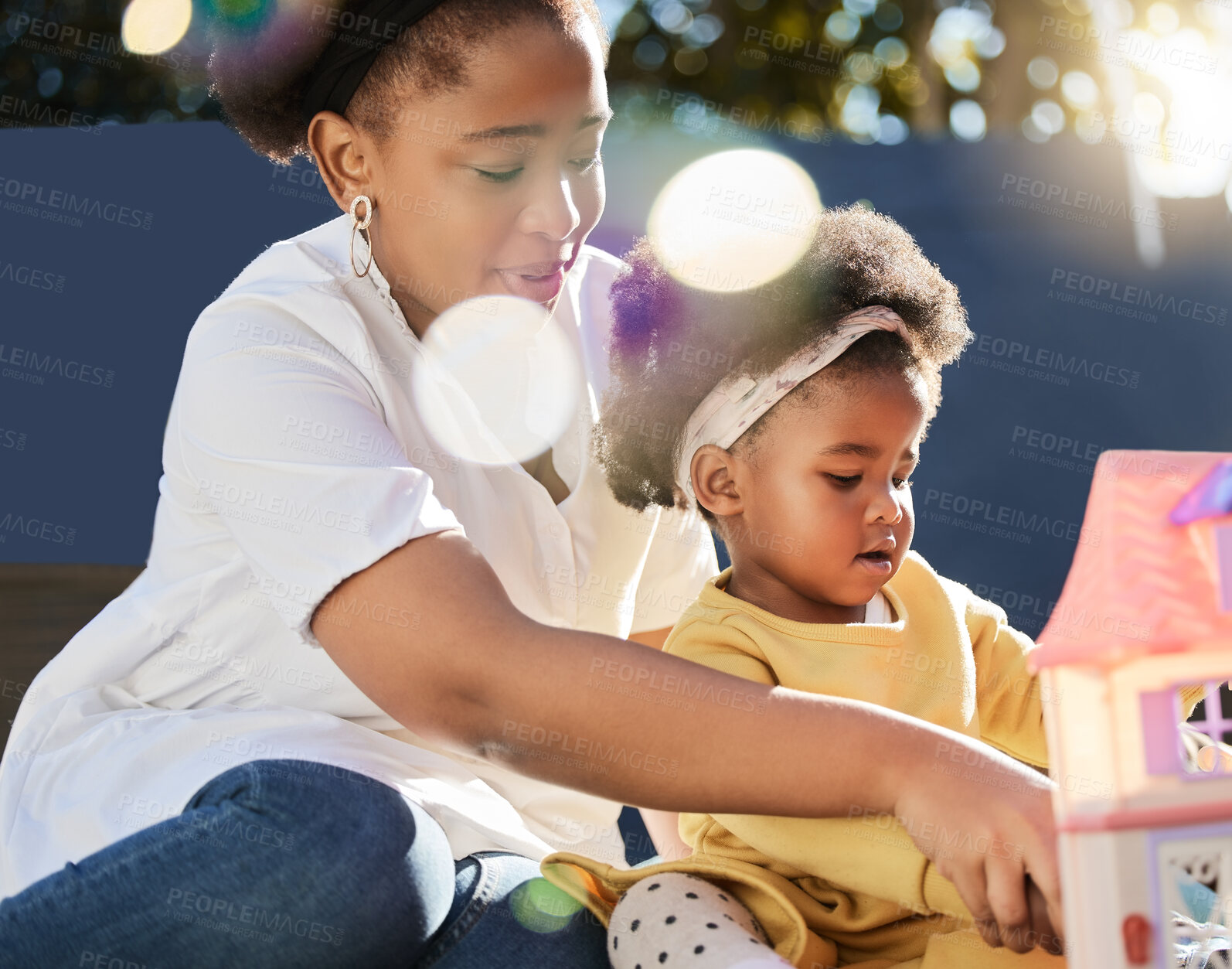 Buy stock photo Shot of a young mother and daughter playing in a garden