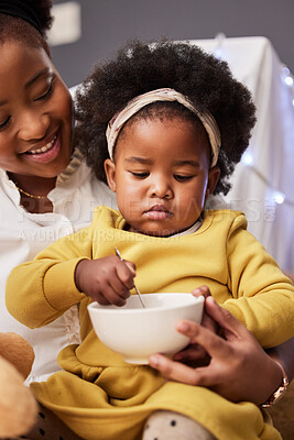 Buy stock photo Shot of a little girl eating breakfast with her mother at home