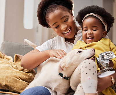 Buy stock photo Shot of a young mother and daughter relaxing with their pet at home