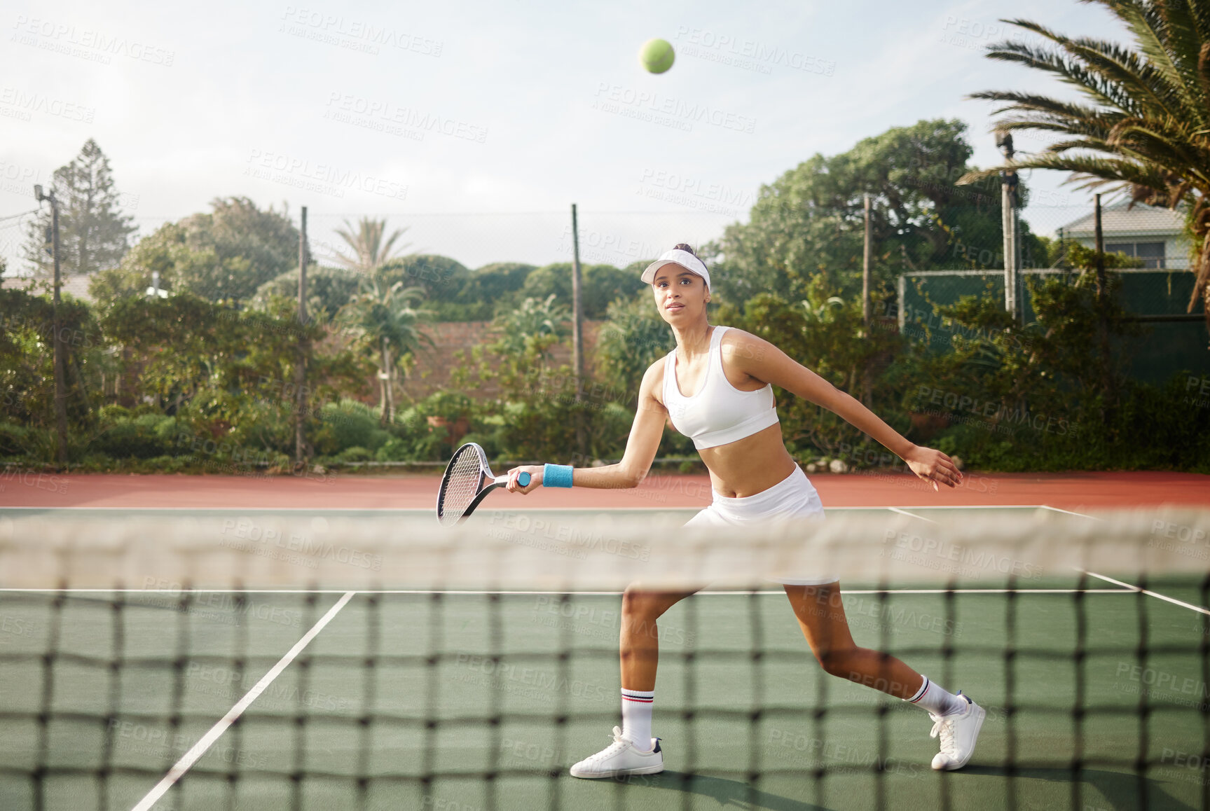 Buy stock photo Shot of an attractive young woman playing tennis outside