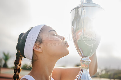 Buy stock photo Shot of an attractive young tennis player holding up a trophy