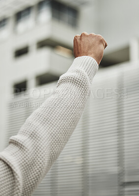 Buy stock photo Rearview shot of an unrecognizable man raising his fist in protest while fighting for his rights