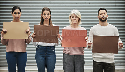 Buy stock photo Cropped portrait of a group of diverse people holding signs while taking part in a political rally