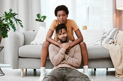 Buy stock photo Portrait, black couple and love in living room, man and woman with hug, romance or relax in home for break. House, African person and partner in lounge, embrace and serious of marriage and commitment