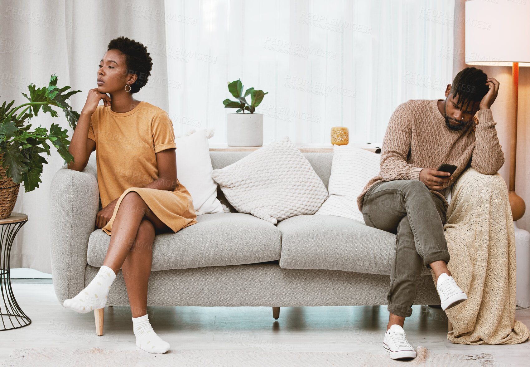 Buy stock photo Shot of a young couple having an argument at home