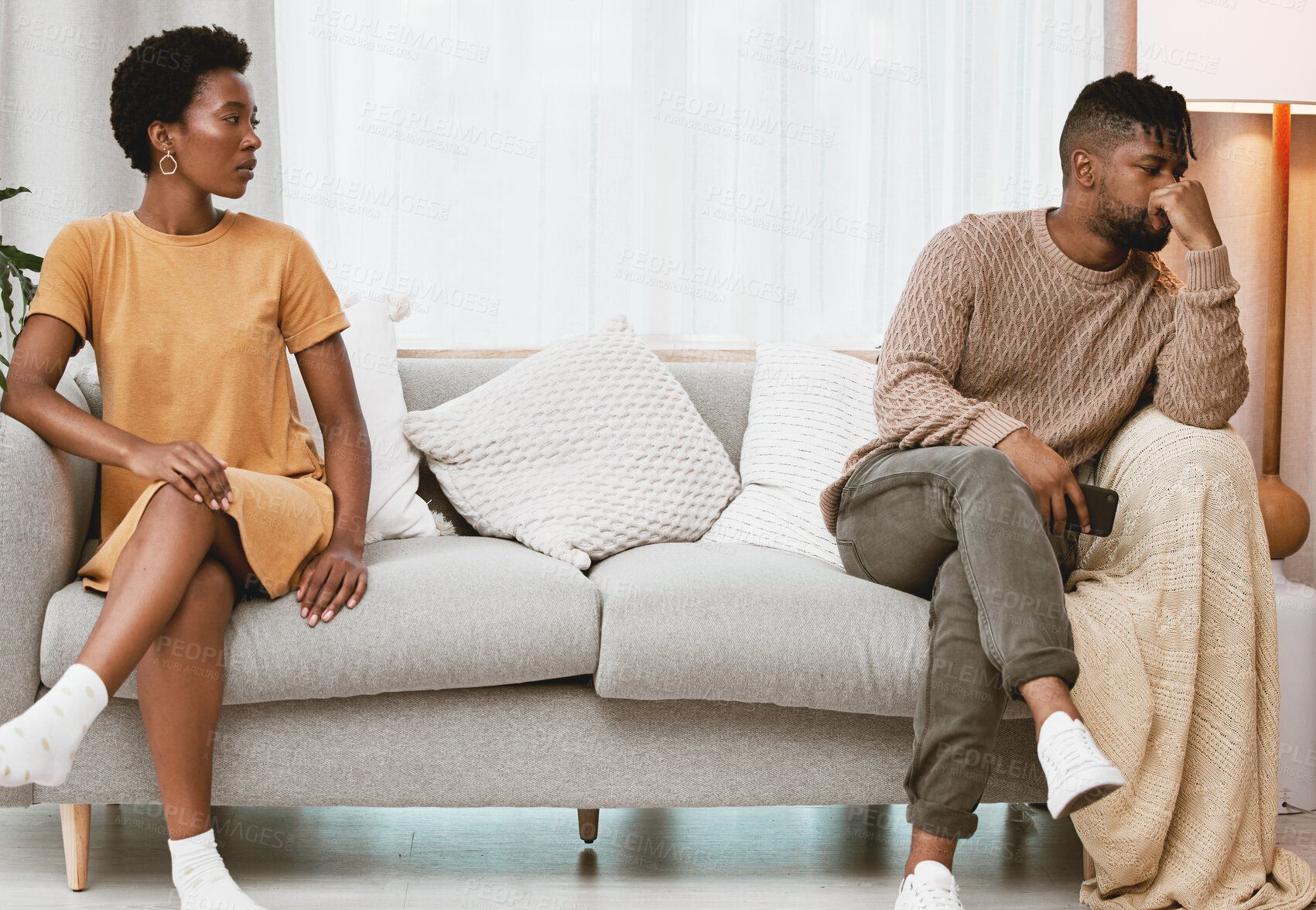 Buy stock photo Shot of a young couple having an argument at home