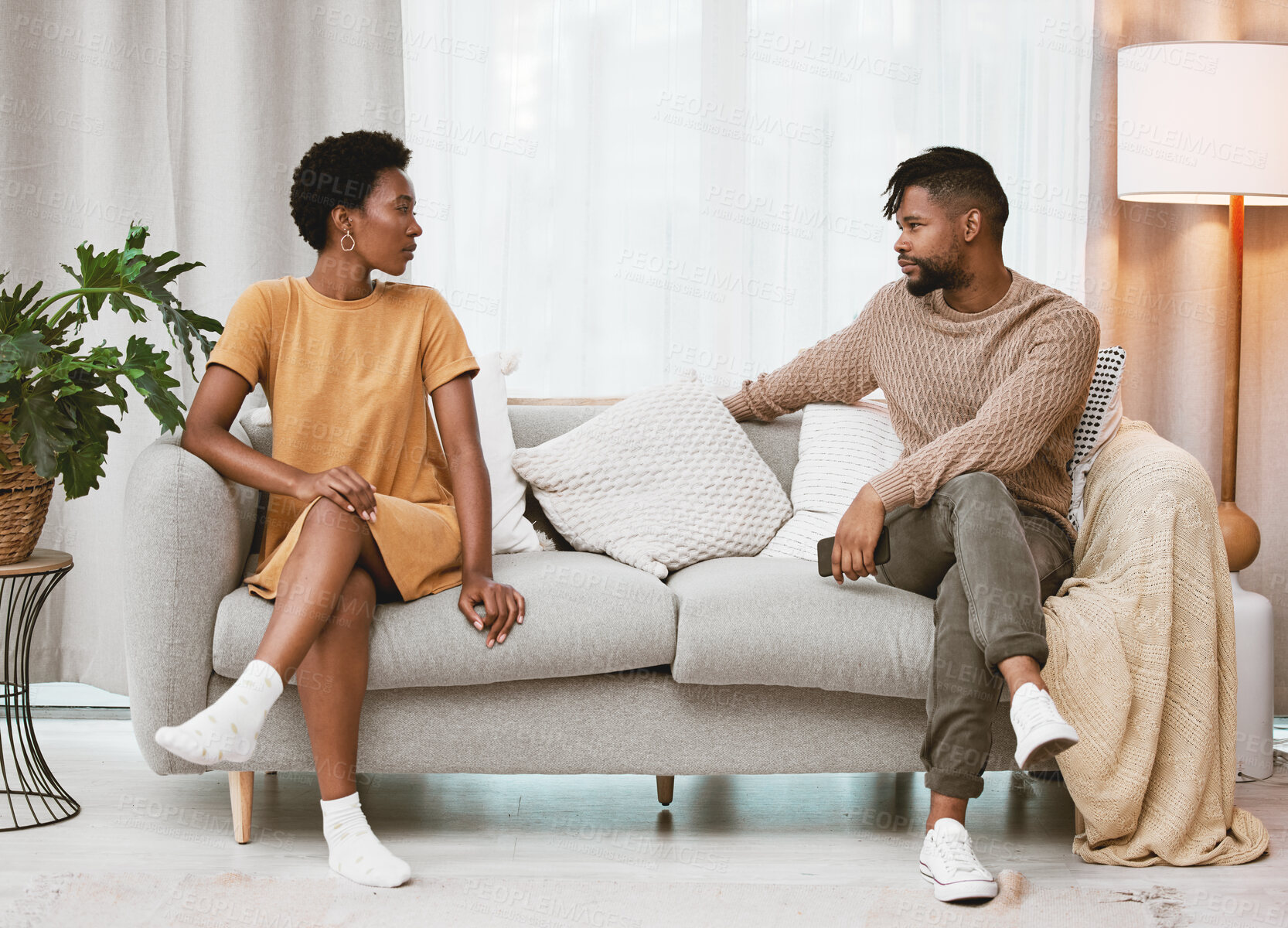 Buy stock photo Couple, fight and talking about divorce of marriage on couch with conflict, challenge or communication. Angry, people or problem in relationship and sorry for cheating, affair or conversation in home