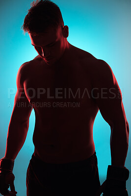 Buy stock photo Studio, boxer or man with gloves by blue background for fitness, training and preparation for competition. Male fighter, exercise and workout with planning, thinking and wellness for boxing sports